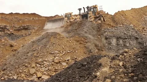 Two Tractors Pushing Dirt Down a Hill Video stock 22243536