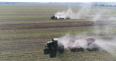 Two tractors working in the field, sowing crops. sunshine 4k Stock Footage 124902072