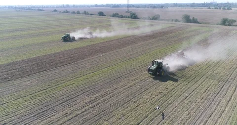 Two tractors working in the field, sowing crops. sunshine Stock Footage 124902170