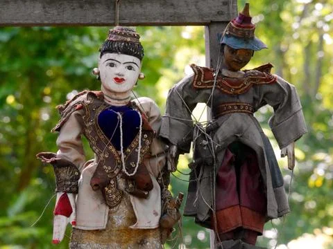 Two traditional handmade string puppets hanging on tree, Myanmar Stock Photos