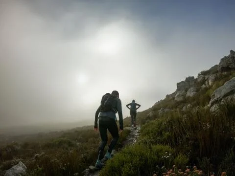 Two trail runners high up on on a mountain with mist Stock Photos