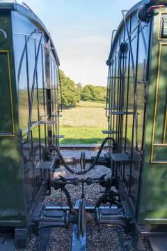 Two train carriages connected together Stock Photos
