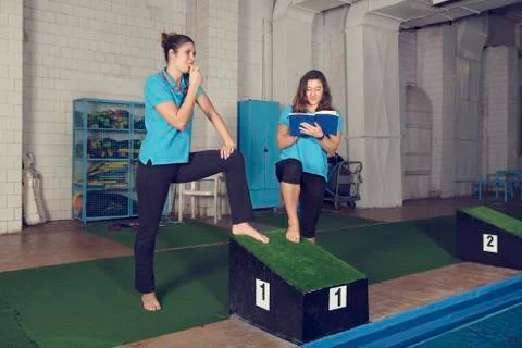 Two Trainers Swimming Pool Stock Photos