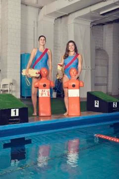 Two Trainers With Training Dummy at a Pool Stock Photos