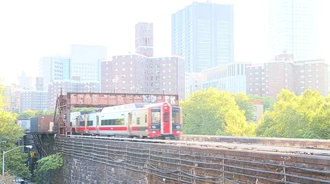 Two trains pass during golden hour in Harlem Stock Footage 55617643