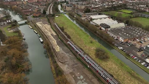 Two trains pass each other in rural town Stock Footage 231862744