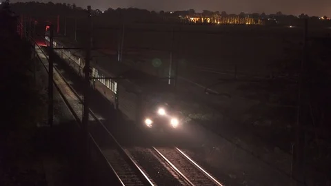Two trains passing at night in opposite directions, high quality night footage Stock Footage 90138890