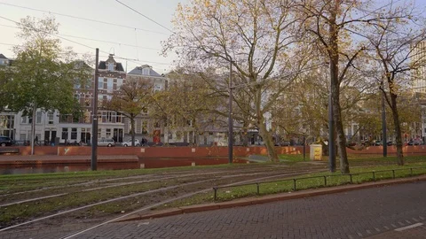 Two Trams following each other on the Mauritsweg road towards the central train Stock Footage 126060626