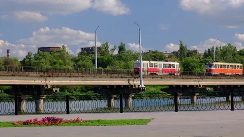 Two trams moves along the bridge over the river in a Kryvyi Rih city, Ukraine. Stock Footage 112976645
