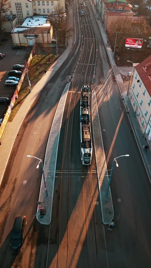 Two trams pass in opposite directions on narrow street — Poland 2026 Stock Footage 327312485
