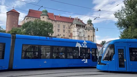 Two Trams Passing Each Other on a Street in Krakow, Poland Stock Footage 345122342