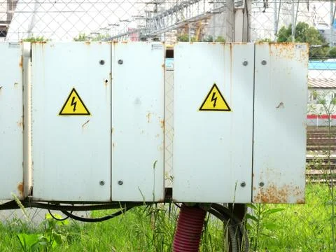 Two transformer boxes with a caution sign Stock Photos