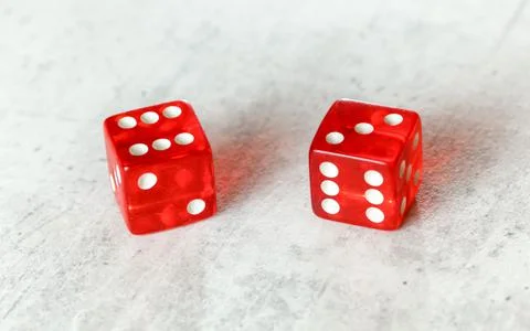 Two translucent red craps dices on white board showing Centerfield Nine / Nin Foto stock