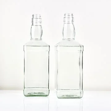 Two transparent bottles on the table Stock Photos