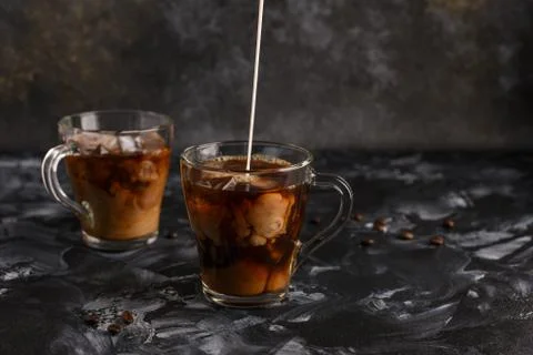 Two transparent cups of cold coffee with milk. Iced coffee. 스톡 사진