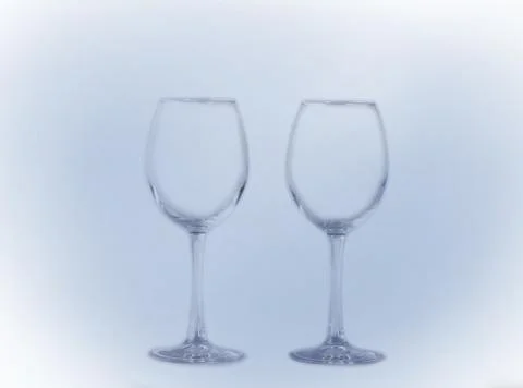Two transparent empty glasses on a long leg Foto stock