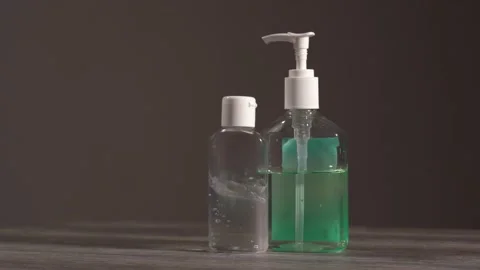 Two transparent jars with gel antiseptic sanitizer radially rotate in a circle  Stock Footage 130858302