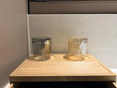 Two transparent jars on a wooden surface. Fotos de archivo