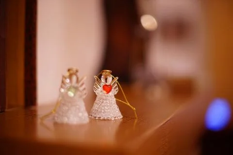 Two transparent statuettes of small angels on the mantelpiece 스톡 사진