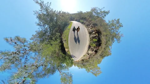 Two Travelers Holding Hands While Walking on a Winding Road, Captured in a Tiny Stock Footage 301934334