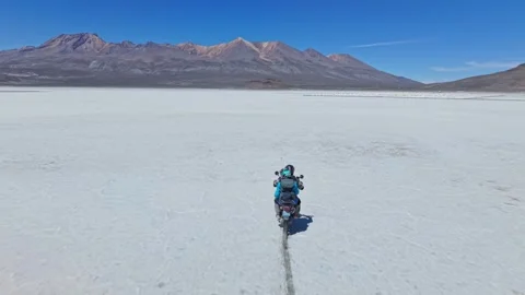 Two Travelling Riders Skid and Snake Across the Famous Salt Flats of Peru as Stockbeeldmateriaal 327770676