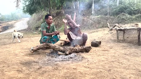 Two Tribal man sitting in front of a fire camp . Stock Footage 240253987