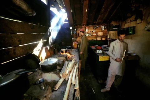Two tribes man cooking in the kitchen in mahodant lake Stock Photos