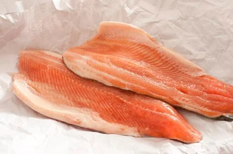 Two trout fillets displayed on paper Stock Photos