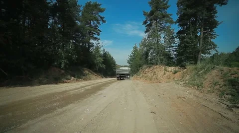 Two truckloads of sand had left on a forest road, a sand pit with trucks. severa Stock Footage 47388607