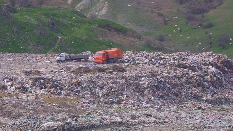 Two trucks are dumping garbage. Environmental pollution. Stock Footage 105637227