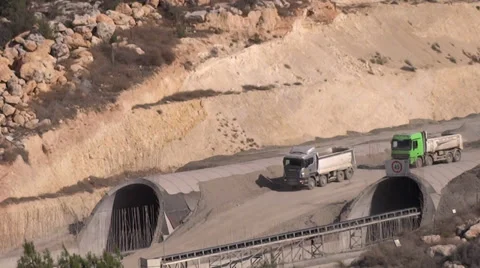 Two trucks driving over construction road Stock Footage 33741187