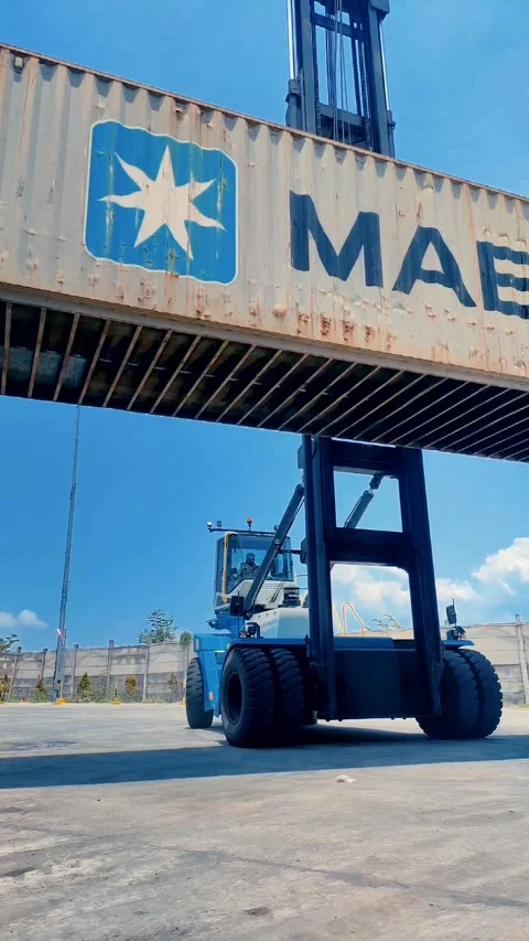 Two trucks positioned in front of a towering stack Stock Footage 312021794