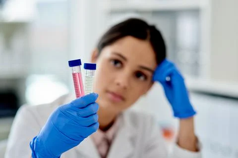 Two tubes to test. a young scientist analysing samples in test tubes in a lab. Stock Photos
