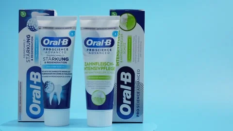 Two tubes of toothpaste, one of which is blue and the other is white Stock Footage 293607809