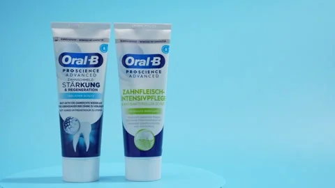 Two tubes of toothpaste, one of which is called Oral B Stock Footage 293608125