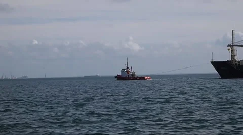 Two Tug Boats pulling a large Ship in Setubal Portugal Stock Footage 35730658