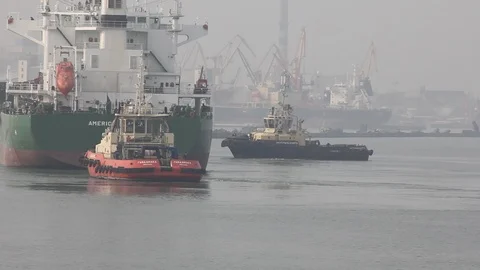 Two tugboats help to deploy a dry cargo ship in the port. Stock Footage 88157098
