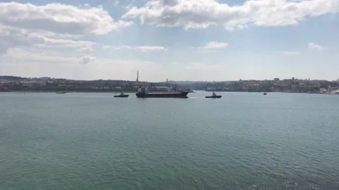 Two tugboats pulling an old barge along the sea strait Stock Footage 152166803