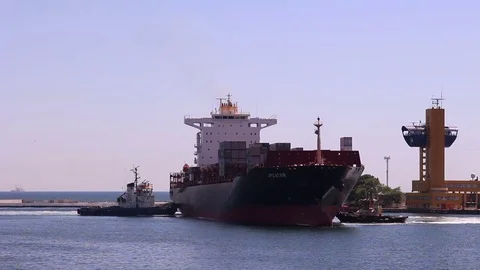 Two tugs assisting container ship to turn around in Odessa port harbor Video stock 71553234