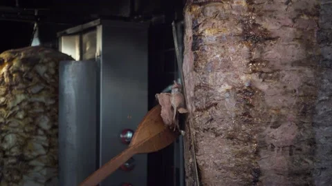 Two Turkish chefs slicing the famous and most delicious street food doner keb Stock Footage 144485894