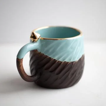 Two turquoise cups for tea or coffee on the white table Stock Photos