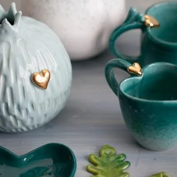 Two turquoise cups for tea or coffee on the white table Stock Photos