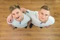 The two twin brother smile to the camera. View from above Photo