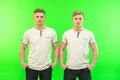 The two twin brother stand on the green background Photo
