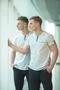 The two twin brother stand near the panoramic window Photo