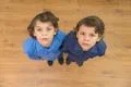 The two twin kids look to the camera. View from above Photo