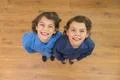 The two twin kids smile to the camera. View from above Photo