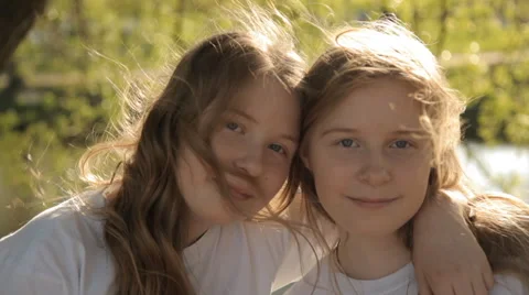 Two twin sisters standing in the wind and hug Stock-Footage 63052370