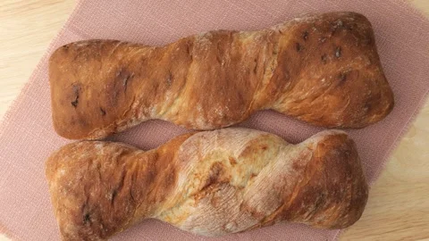 Two twisted loaves of bread rotating Stock Footage 346177738