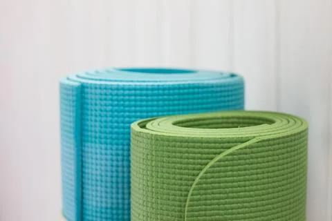 Two twisted yoga mats. Blue and green Stock Photos
